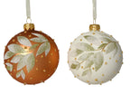 Two Christmas ornaments with leaf patterns on a white background