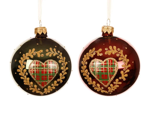 Two Christmas ornaments with plaid hearts and gold wreaths on a white background
