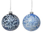 Two blue Christmas ornaments with silver floral patterns on a white background