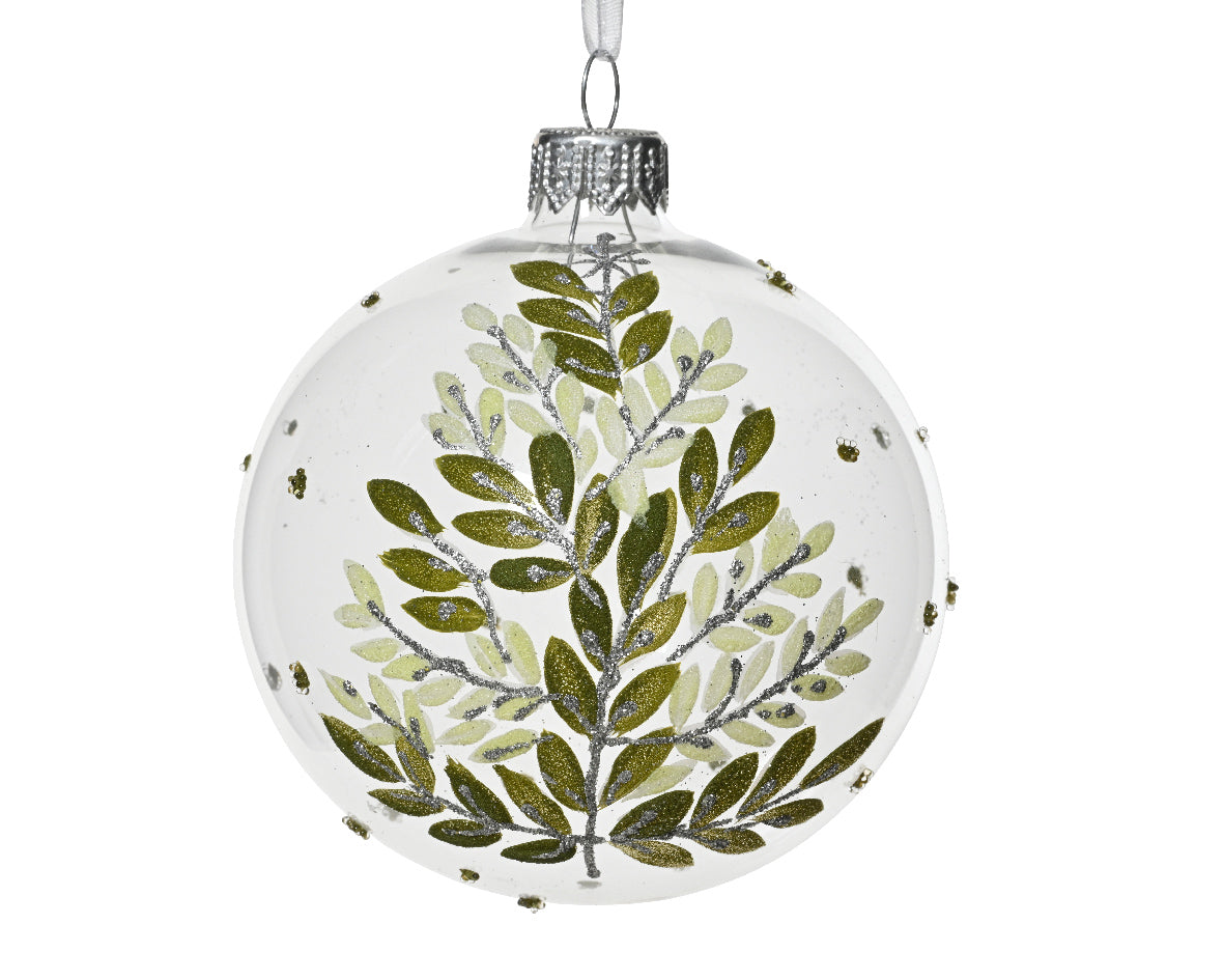 Decorative glass ball ornament with green leaf pattern on a white background