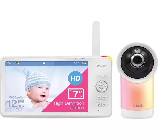 Vtech wireless baby monitor and camera set on a white background, featuring a white LCD monitor with a colorful screen and a white camera with a pink-to-yellow gradient base.