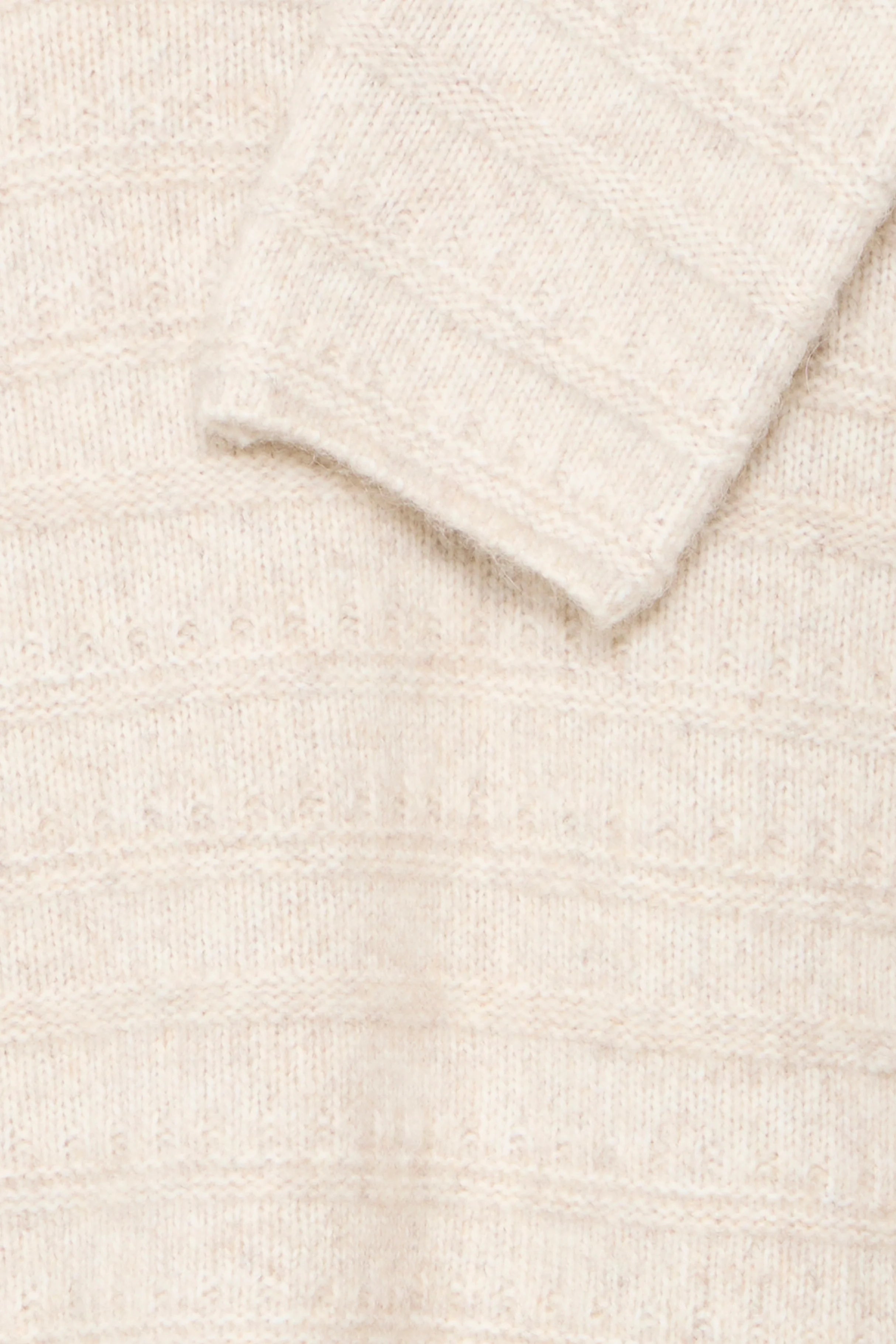 Close-up of a textured beige fabric surface