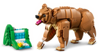 Toy bear and cave made of interlocking bricks on a white background