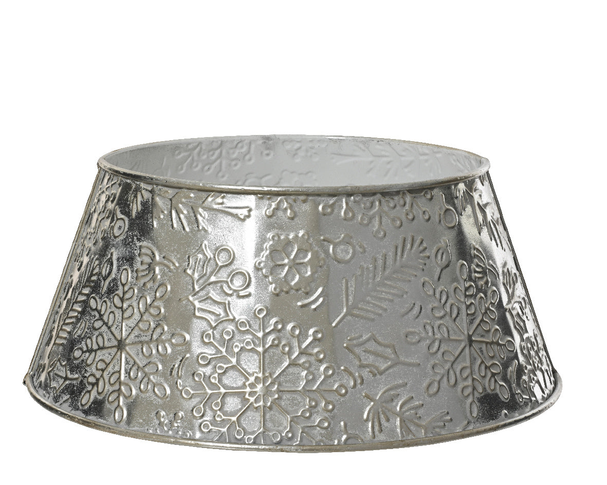 Decorative metal tree collar with snowflake pattern on a white background