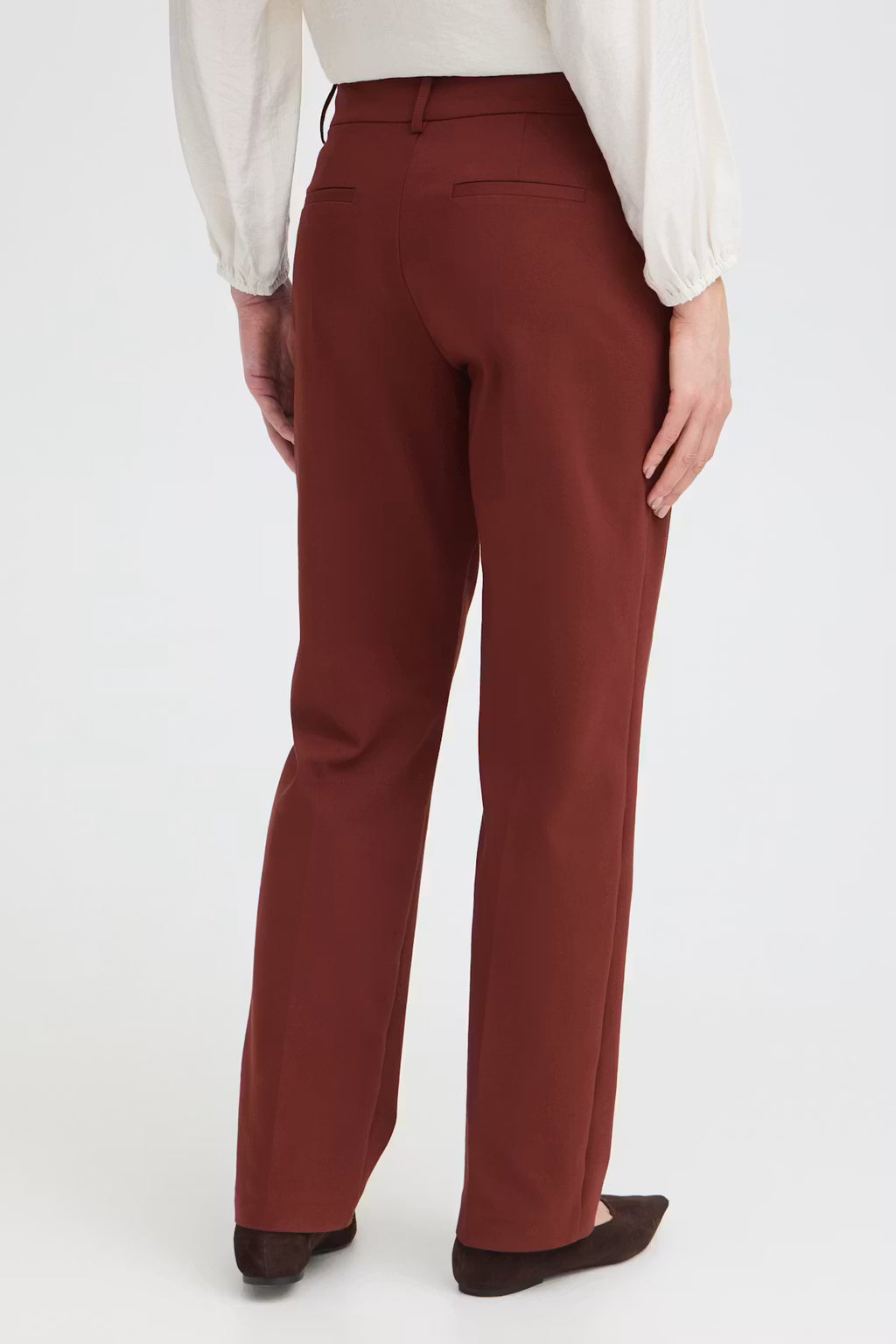 
Rum Raisin / Red straight-leg trousers shown on a model from the back, paired with a white blouse and dark brown flats against a clean white background.