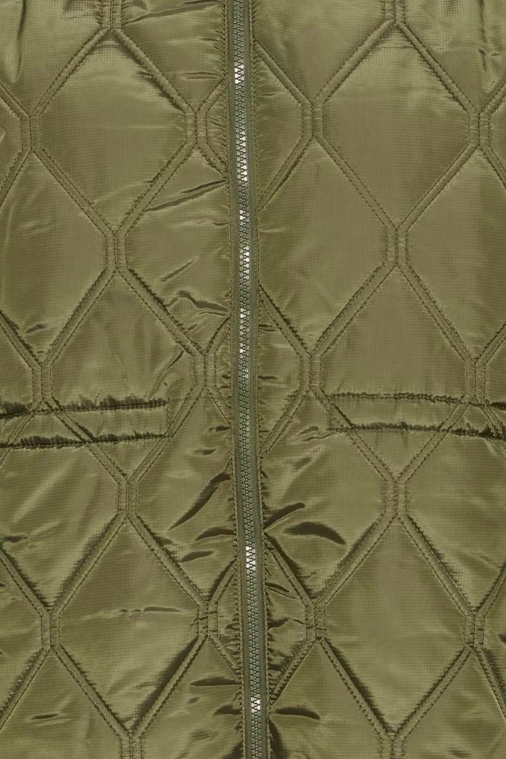 Close-up of a quilted jacket FRAGATE Outerwear in Grape Leaf/Green with a central zipper and stitched diamond pattern.