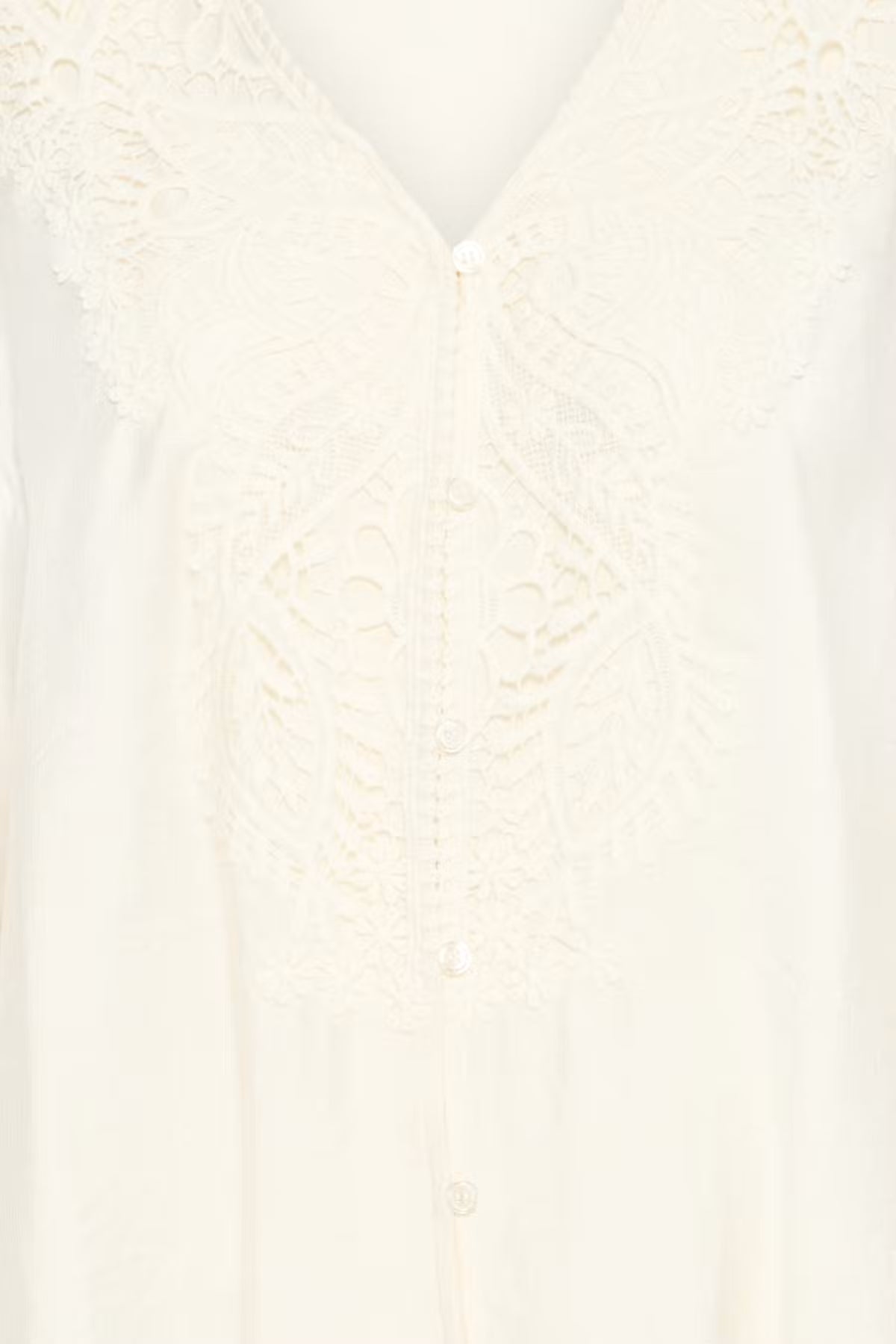 Close-up of a Whisper White lace and satin button-front garment, showing intricate floral lace embroidery and a V-neckline.
