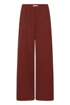 A pair of wide-leg trousers in a deep rust red color, shown flat against a solid white background.