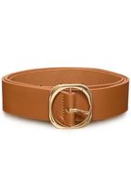 A tan leather belt with a large, polished gold-tone double-ring buckle, coiled and presented on a clean white background.