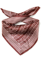 A square rum Raisin scarf tied in a knot, featuring a geometric herringbone pattern in white on a deep burgundy background, set against a plain white studio background.