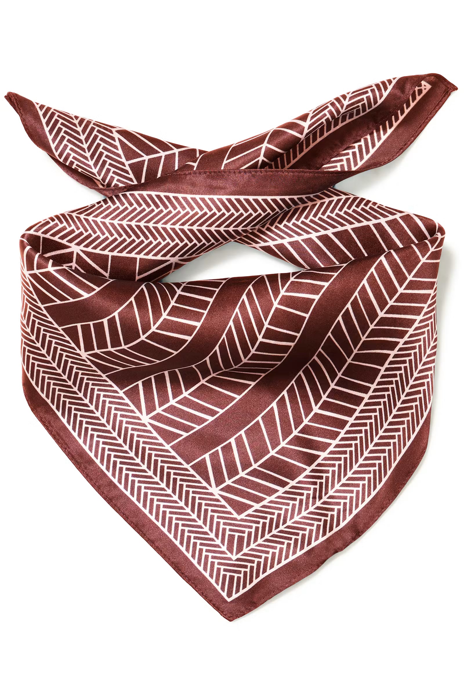 A square rum Raisin scarf tied in a knot, featuring a geometric herringbone pattern in white on a deep burgundy background, set against a plain white studio background.