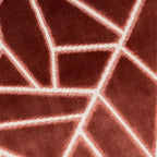 A close-up of Veda Cushion in Antique Rose textured fabric with a white geometric line pattern.