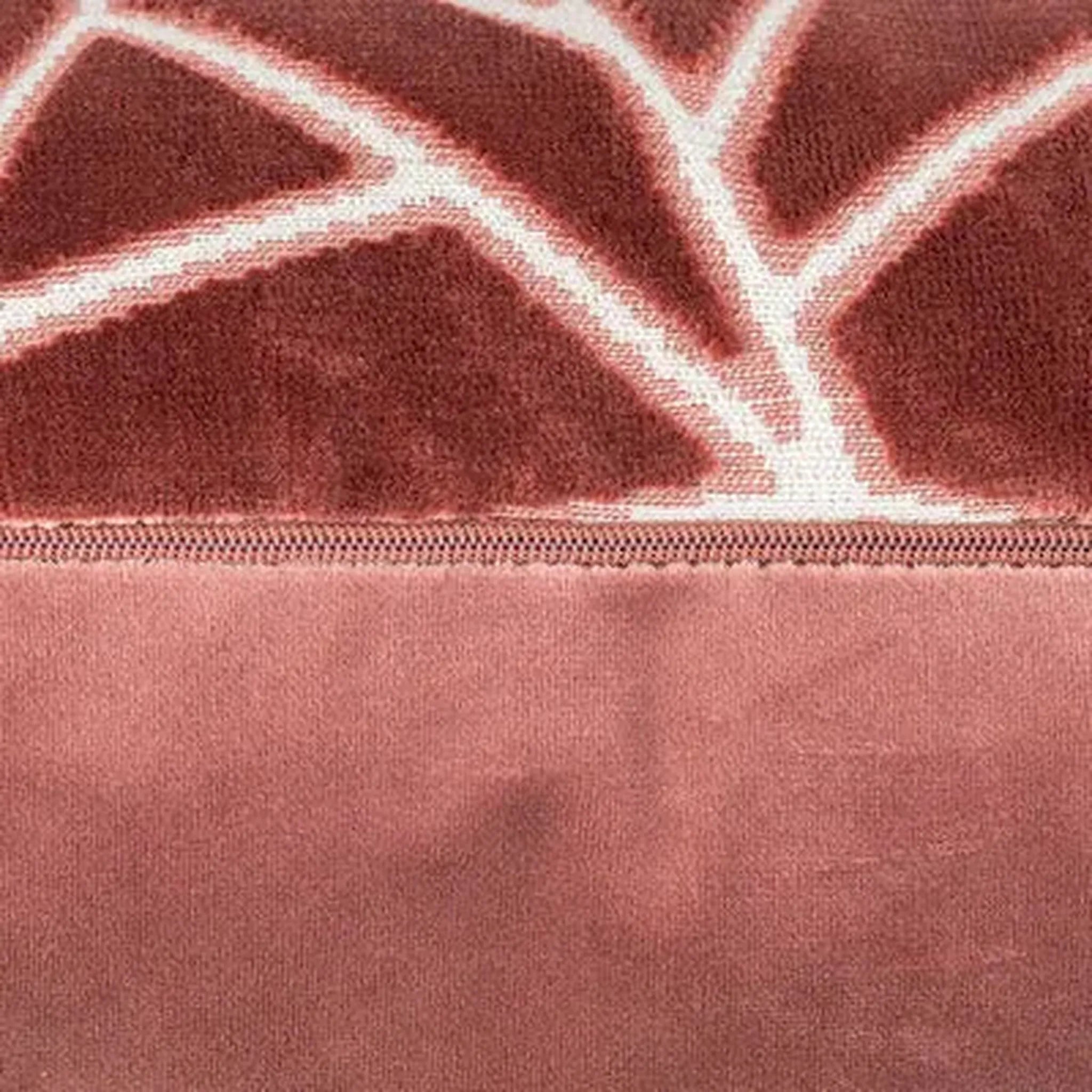 Close-up of a Veda Cushion in Antique Rosefabric product, likely a blanket or throw, featuring a textured upper section with a white geometric branch-like pattern and a smooth lower section.