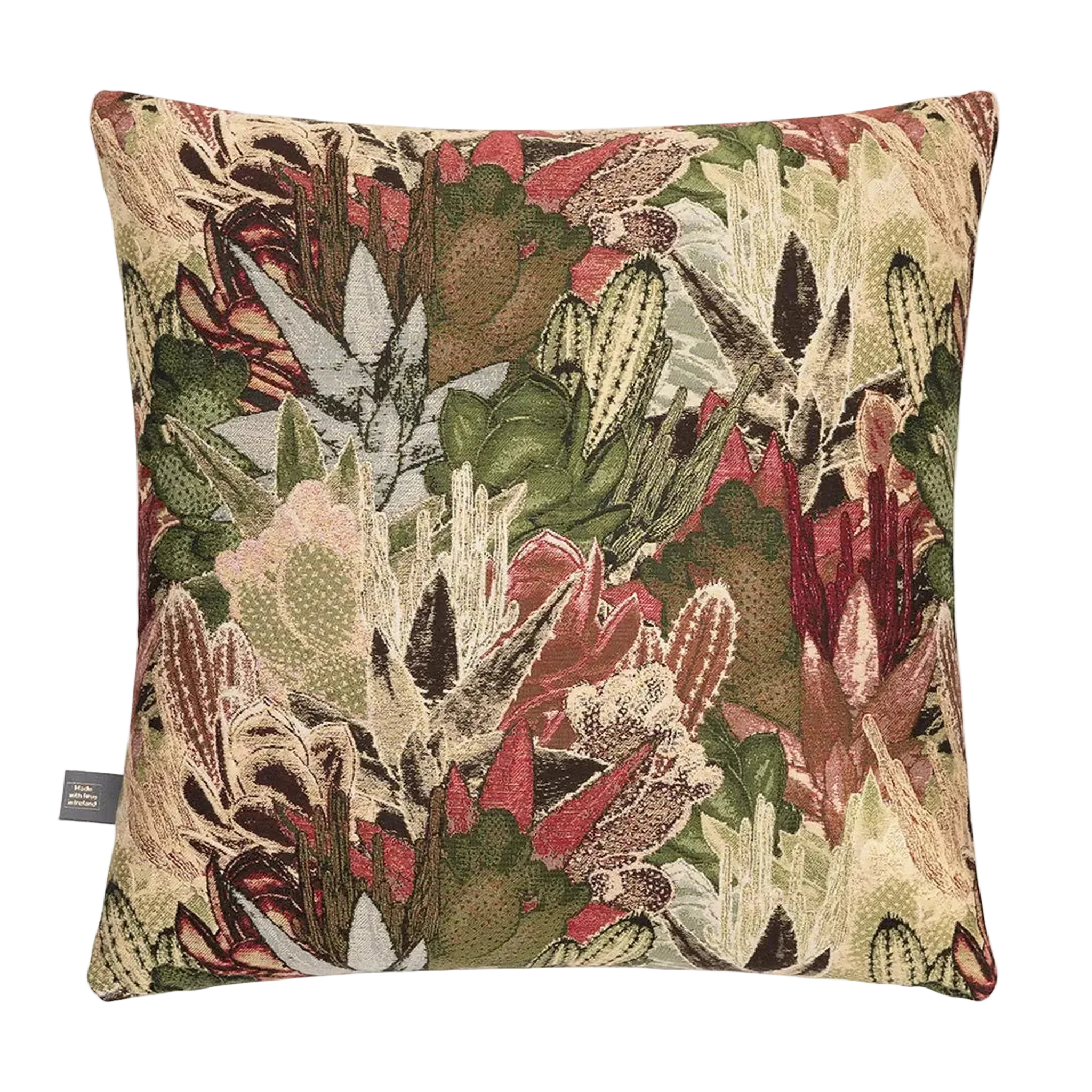 A square decorative Merida Cushion in Green  featuring a detailed woven botanical pattern of cacti, succulents, and leaves in shades of green, beige, rust red, and brown, shown against a plain white background.