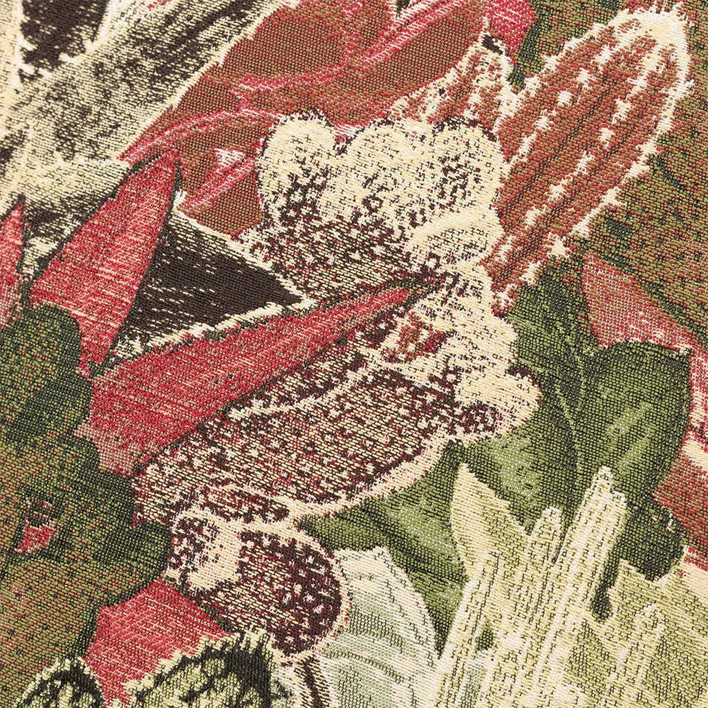 Close-up of a Merida Cushion in Green  floral pattern with red, green, and white colors.