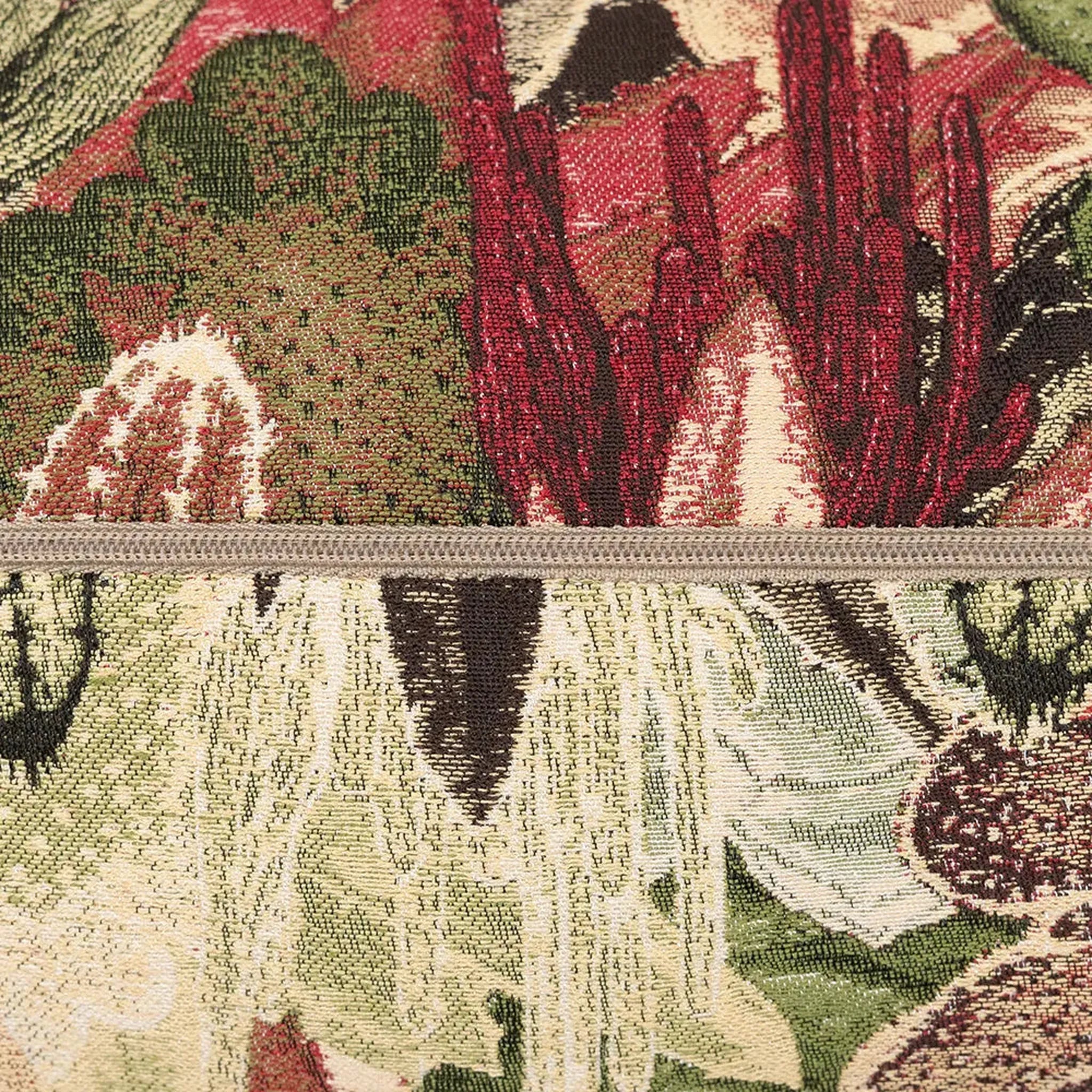 Close-up of a textured fabric with floral patterns in red, green, and beige.
