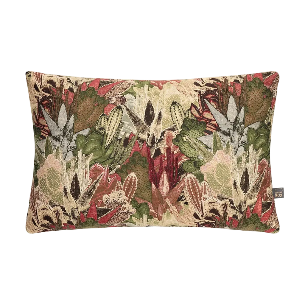 A rectangular decorative Merida Cushion in Green featuring a dense, textured botanical tapestry pattern with green, red, beige, and brown leaves and flowers, shown against a plain white background.