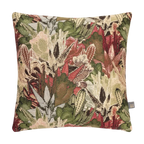 A square decorative Merida Cushion in Green featuring a dense, detailed botanical and cactus pattern in shades of green, red, beige, and brown, shown against a plain white background.