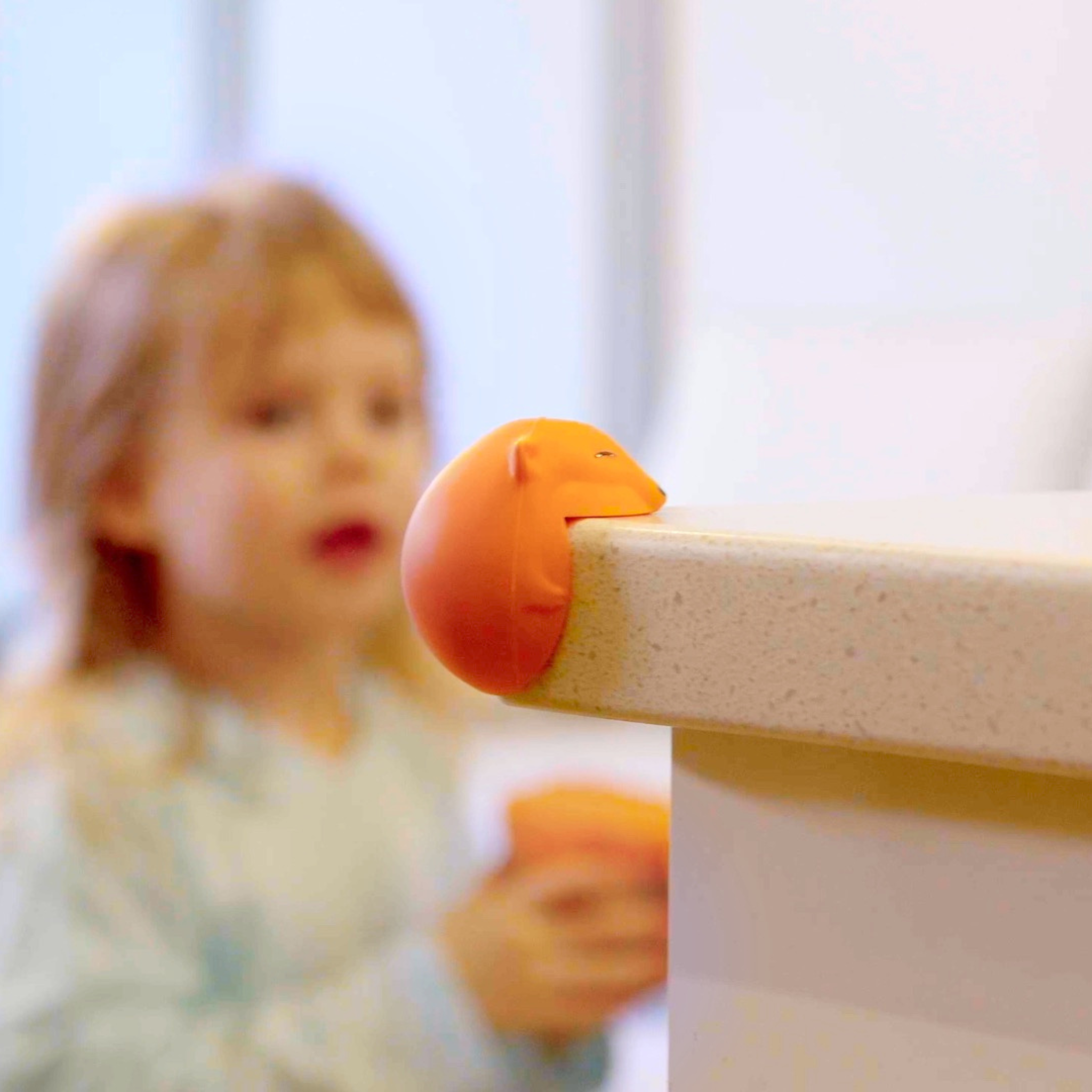 Close-up of Foxxi corner bumper in living room – Cute Silicone Babyproofing Accessory