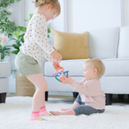 Chillable Baby Teething Toy for Gum Relief with two children playing with the ring