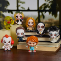 Set of small horror themeed figurines on a wooden stand with a blurred background