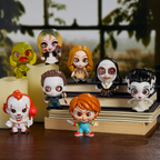 Set of small horror themeed figurines on a wooden stand with a blurred background