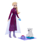 Toy doll in a purple outfit with a white polar bear on a white background