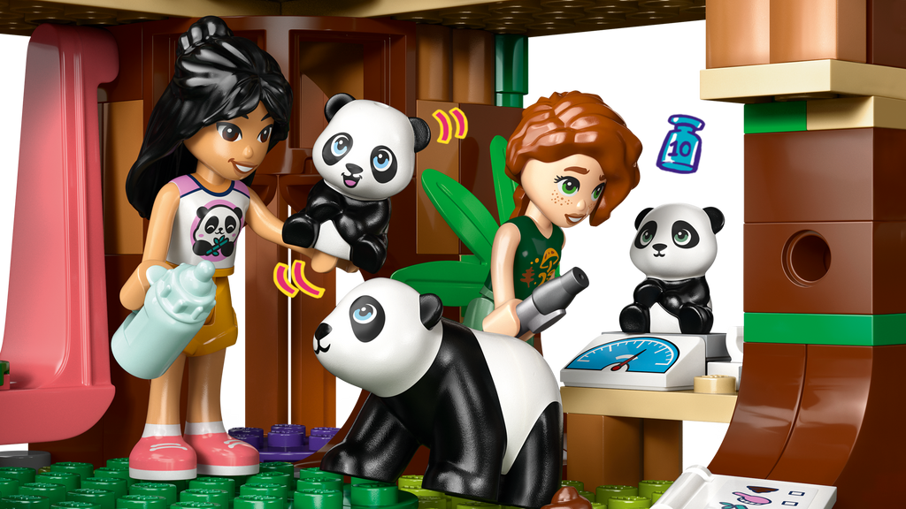 LEGO figures of two girls with panda toys in a playful setting