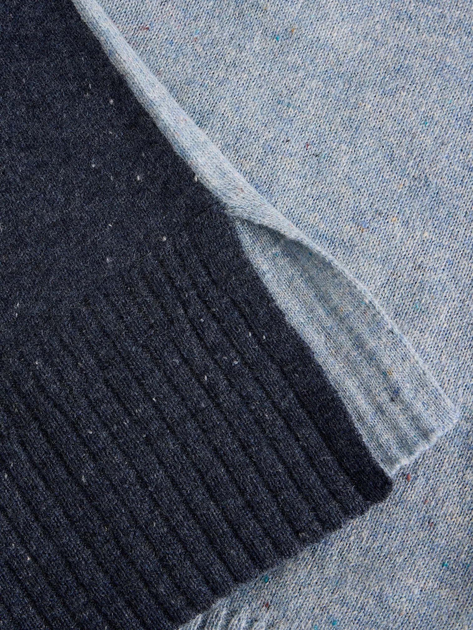 Close-up of black ribbed fabric and blue denim fabric.