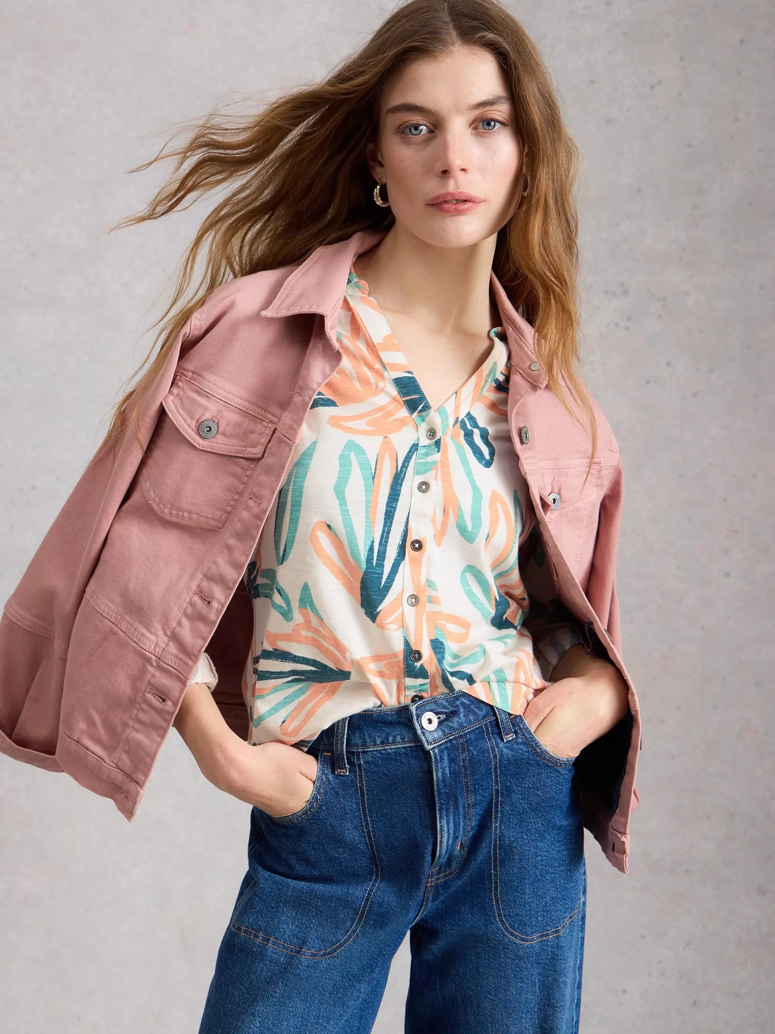 Model wearing White Stuff Annie white jersey shirt with collar and 3/4 sleeves.