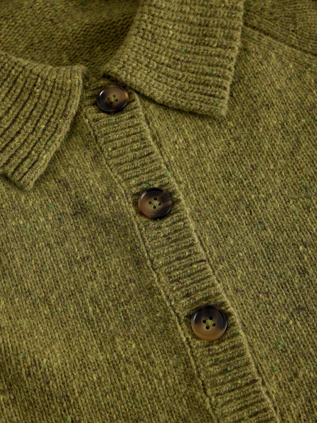 Close-up of an Shepherd Collar Cardi – Mid Chartreuse  dark brown buttons and ribbed collar, placket, and cuffs.