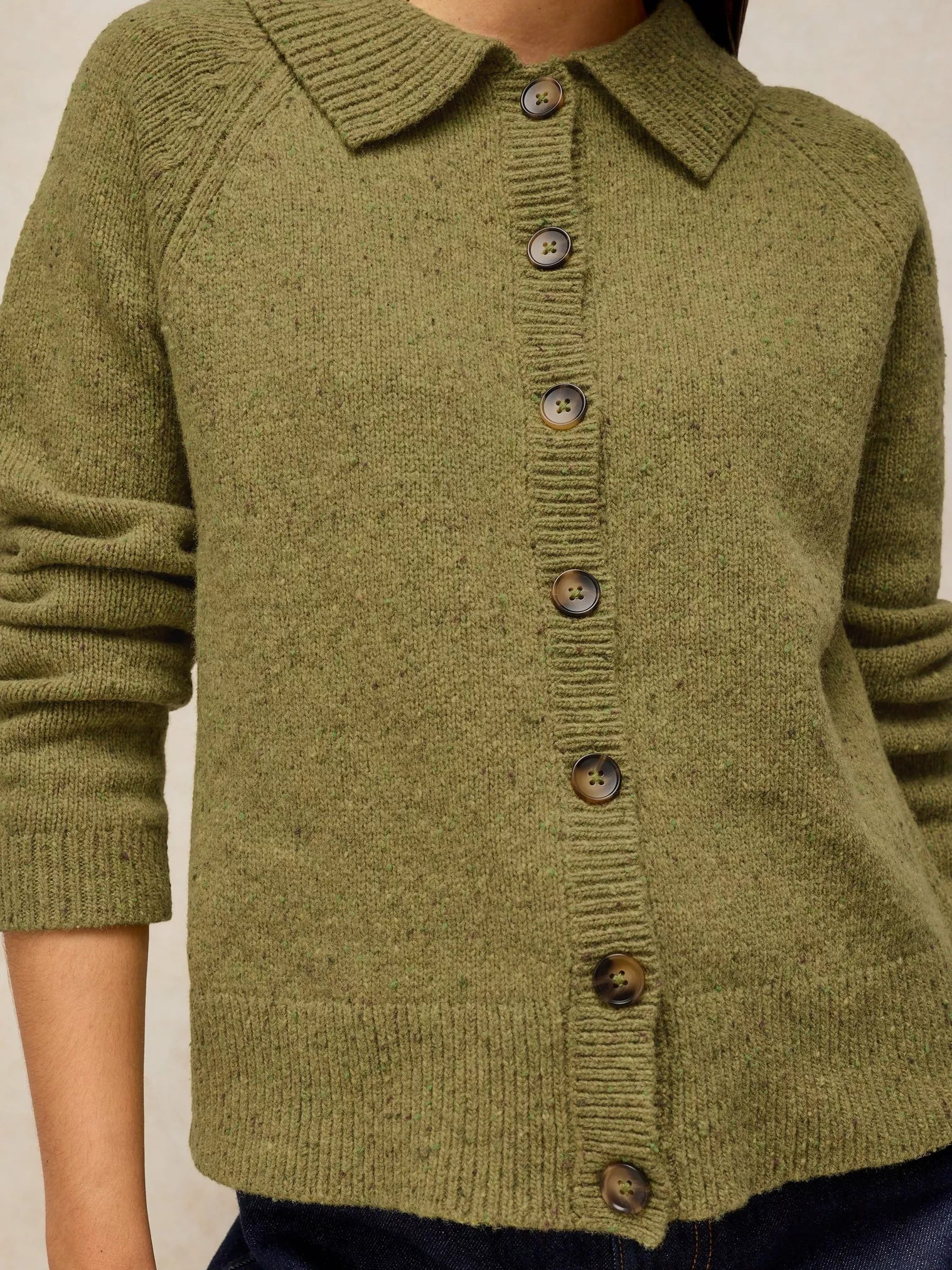 Shepherd Collar Cardi – Mid Chartreuse, with a collar and brown buttons, shown on a model against a neutral beige background.