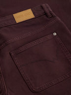 Close-up of TIA brown WIDE LEG CROP JEAN with a visible brand label.