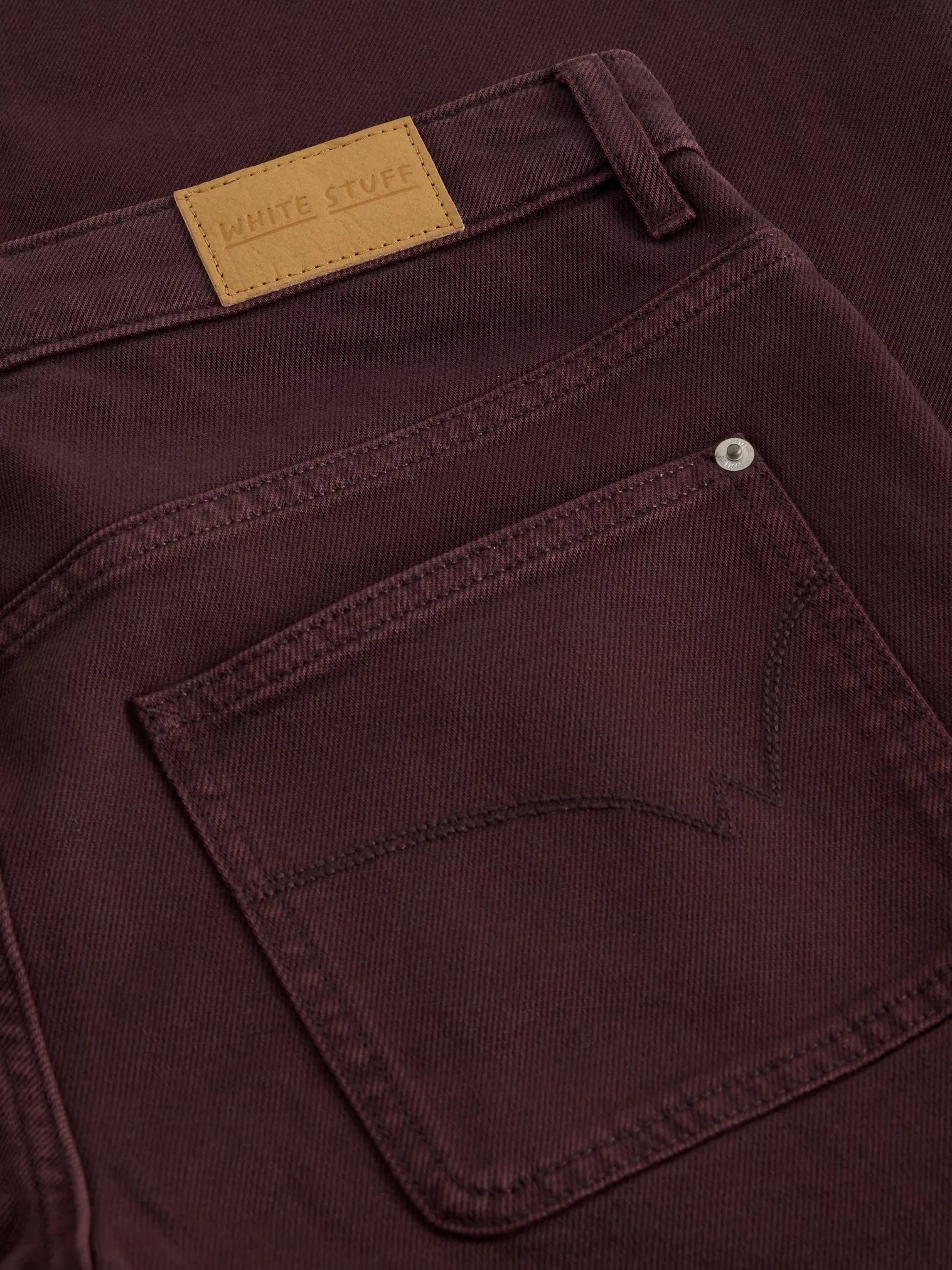 Close-up of TIA brown WIDE LEG CROP JEAN with a visible brand label.