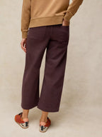 Person wearing TIA brown WIDE LEG CROP JEAN  back view and a beige sweater on a beige background