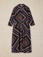Rua Jersey Dress in Navy Multi with a geometric Southwestern pattern in navy, pink, brown, white, and green, laid flat against a light beige background.