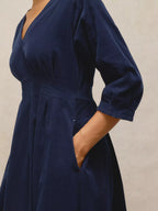 Navy blue dress with a plain background