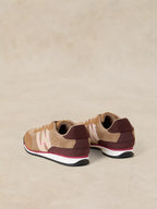 A pair of A Lucy Trainer sneaker in Natural multi shown from the back three-quarter view, featuring a beige and dark brown knit upper with light pink 'W' logos and a white midsole.