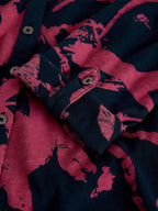 Close-up of a shirt with pink and navy abstract pattern