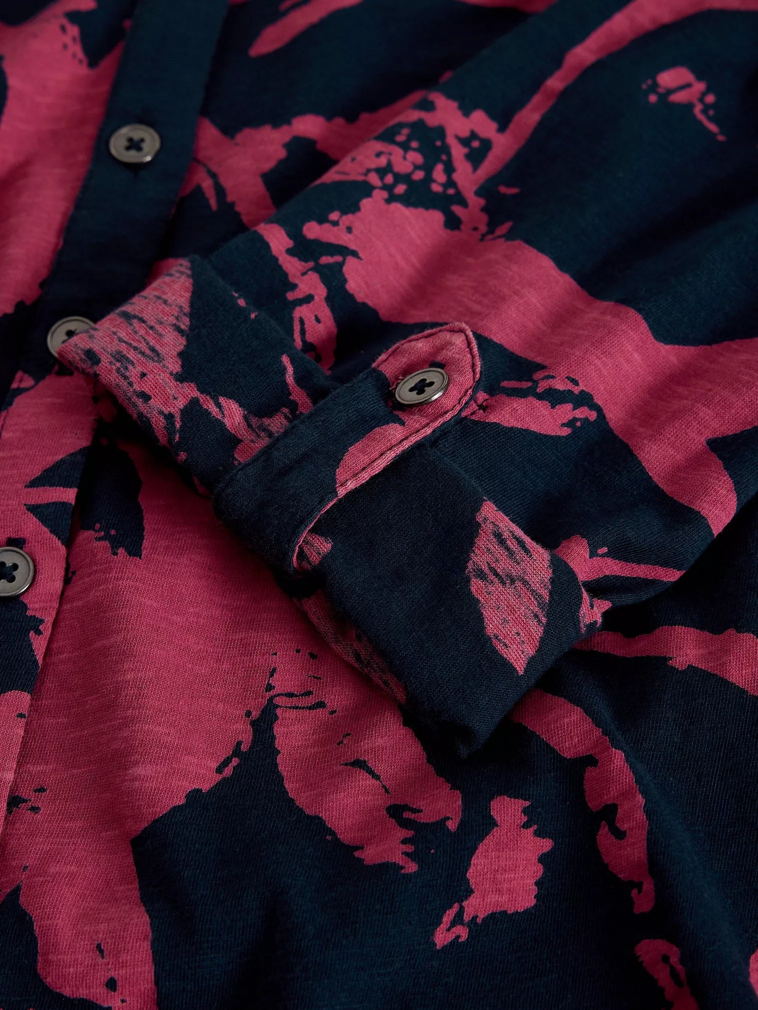 Close-up of a shirt with pink and navy abstract pattern