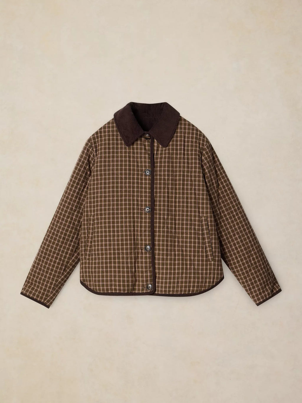 A brown and beige checkered quilted jacket with a solid dark brown collar, laid flat on a textured beige background.