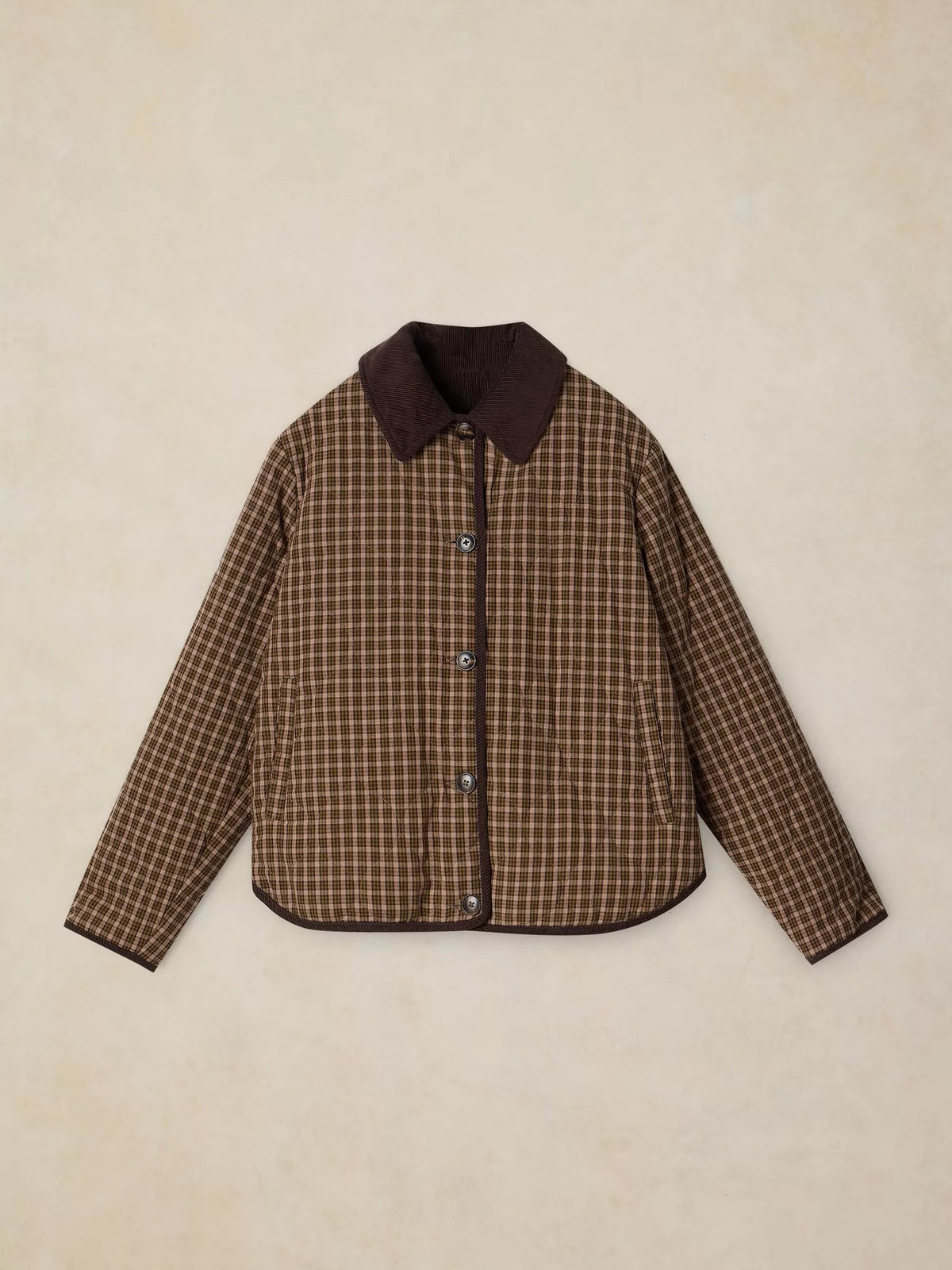 A brown and beige checkered quilted jacket with a solid dark brown collar, laid flat on a textured beige background.