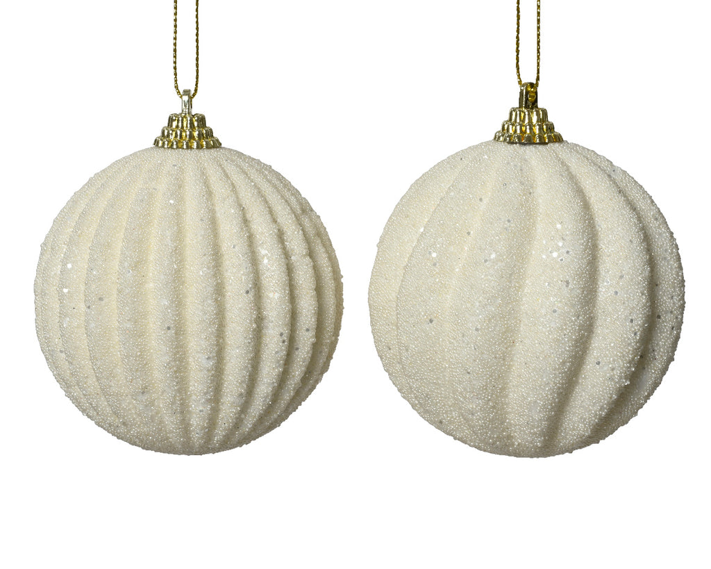 Two beige textured Christmas balls with gold hanging chains on a white background