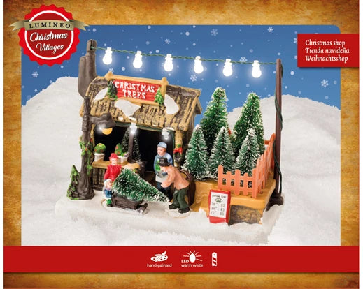 Christmas village scene with a 'Christmas Trees' shop and decorative elements on a snowy base.