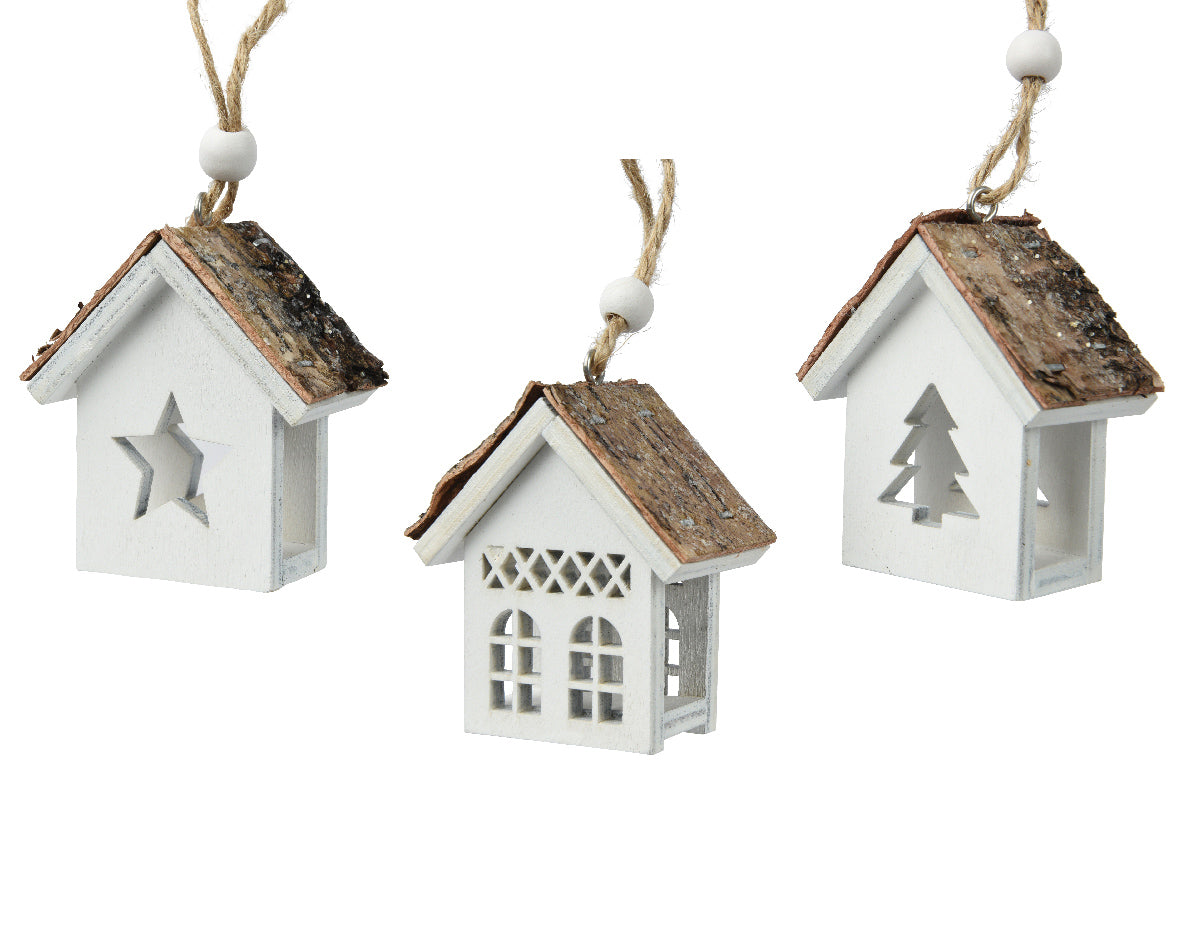 Three white hanging house ornaments with wooden roofs on a white background