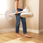 Person holding a white Cecotec EnergySilence 2600 Sunflower Fan in White - full view on a wooden floor.