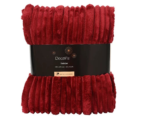 Red textured throw blanket with a black label on a white background