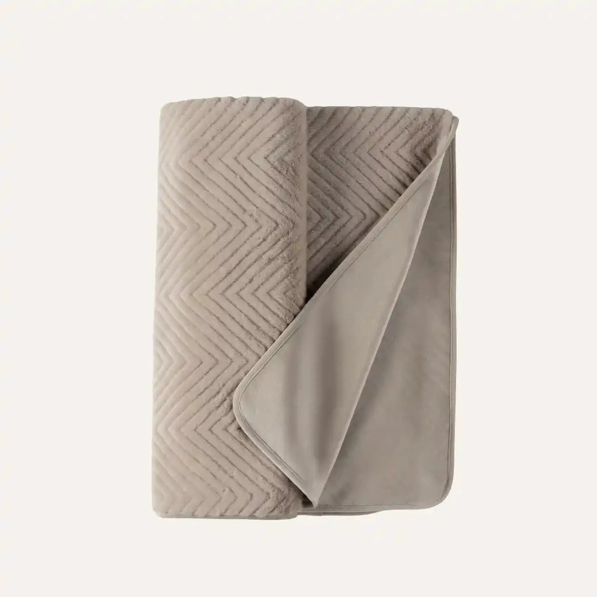 Ellis Throw in Minkin a warm taupe-beige color, featuring a textured chevron quilted pattern on one side and a smooth, solid fabric on the reverse, set against a solid off-white background.
