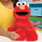 Tickle Me Elmo and a Girl wearing a yellow top in a bedroom background