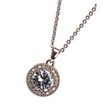 A rose gold necklace with a white stone and diamante pendant, presented on a chain.